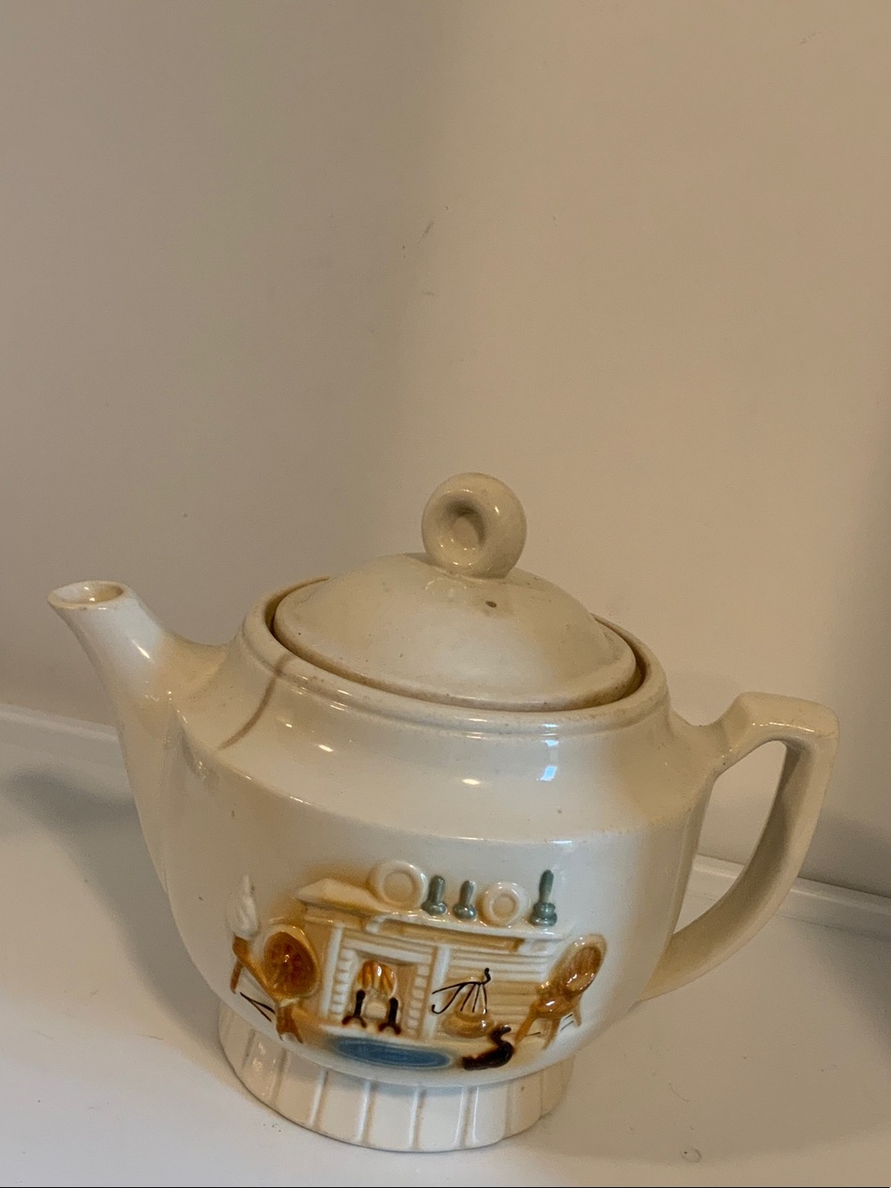 Cream Ceramic Teapot with Decorative Fireplace Motif